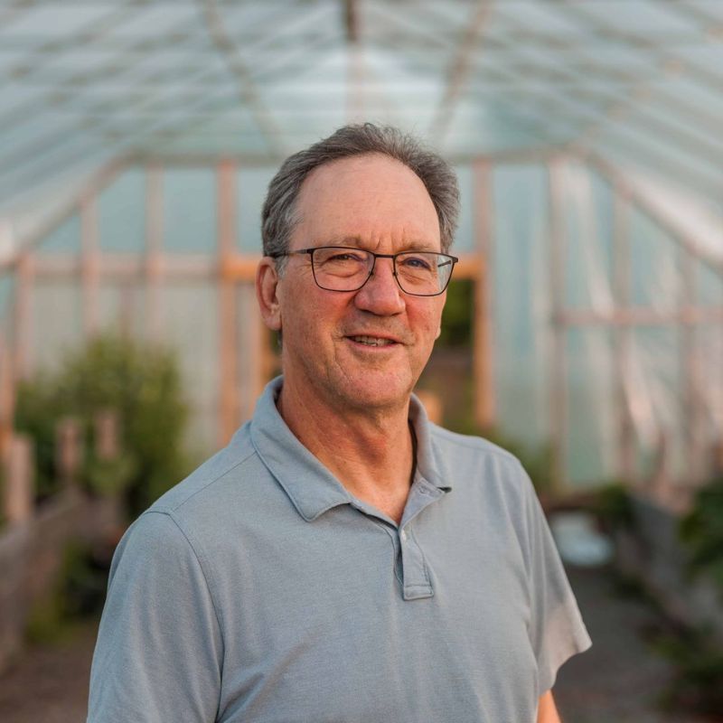 Bio pic of Dr. Cowan in a greenhouse